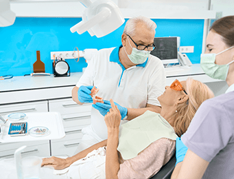 dentist patient and dental assistant looking at a model produced by a dental lab serving the US and Canada