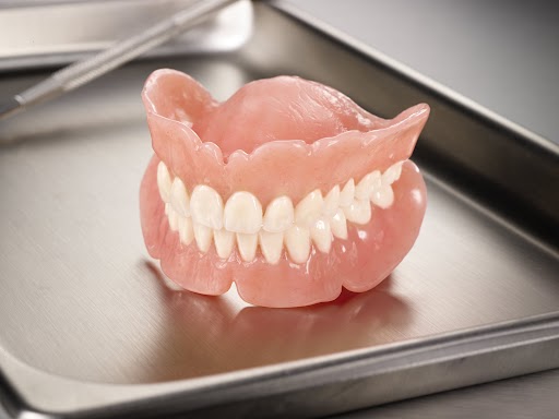 Conventional dentures forming a closed mouth on a tray provided by a dental lab
